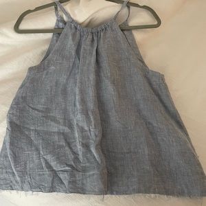 Blue/denimish halter top hemmed with fringe and tied in the back with tassels!